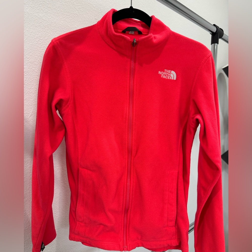 The North Face Girls Fleece Sweater XL. Some signs of wear in color. Orange.